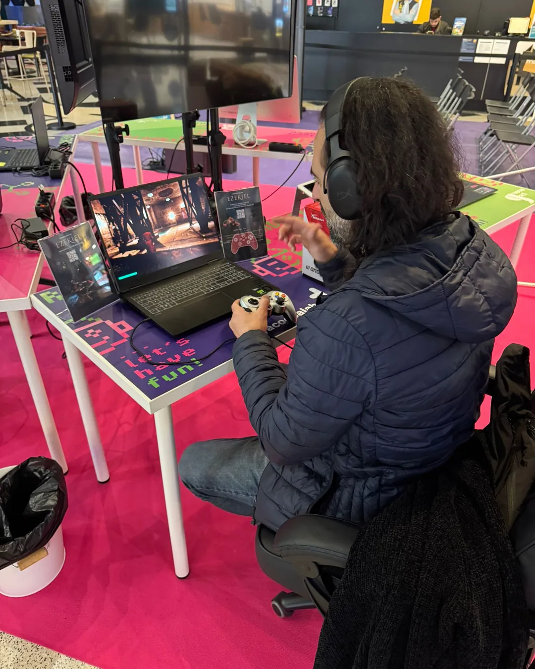 A player running the Ezekiel demo on a gaming laptop with a controller, the game's level on screen.
